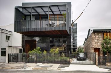 a building with a fence and a car