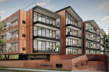 a building with a wood wall and a wooden railing